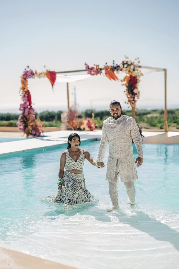 Indian couple in Sicily walking out of the pool